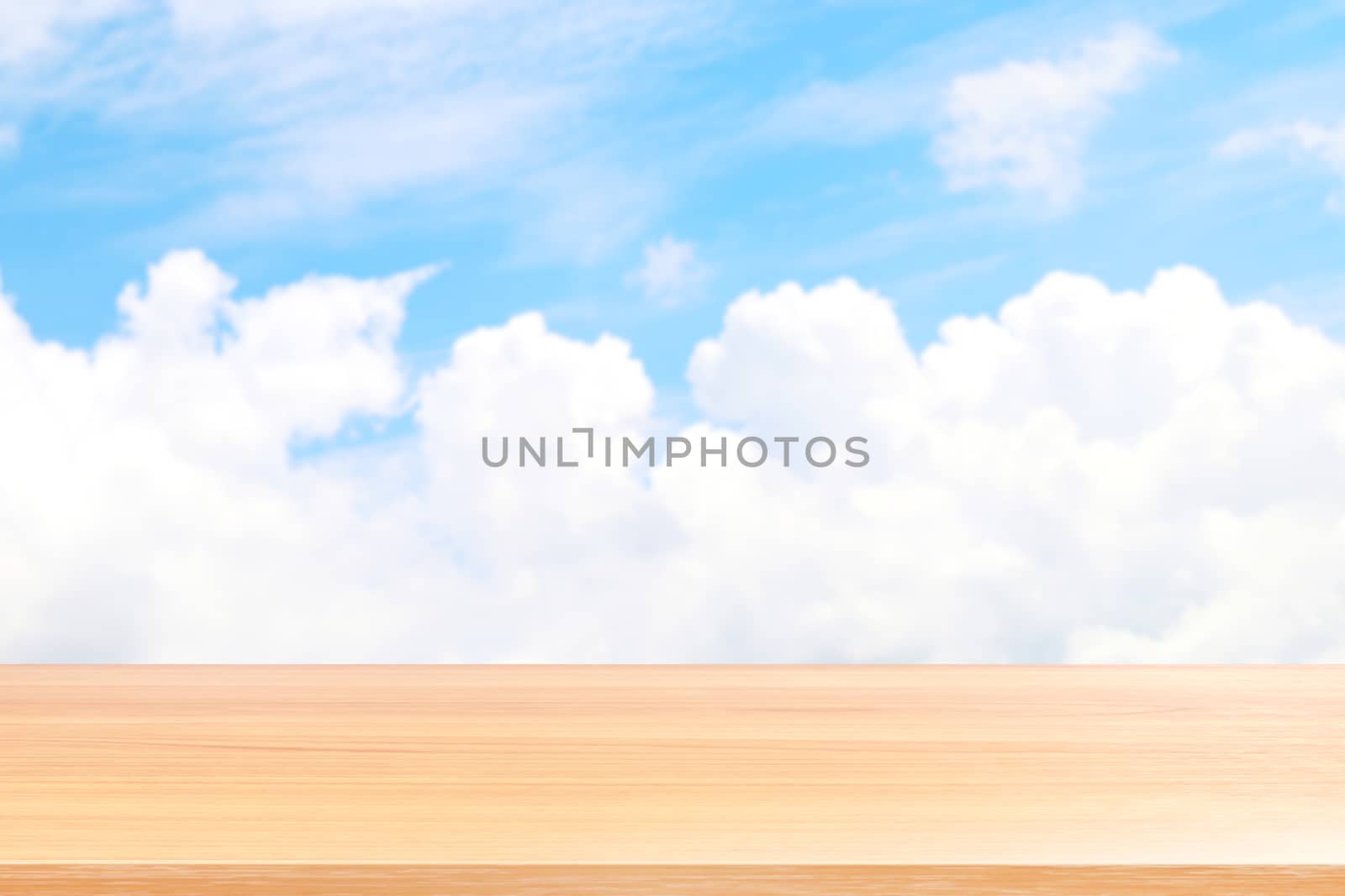 empty wood table floors on blurred blue sky and cloud background, wood table board empty front blur sky blue, wooden plank blank on sky with perspective brown wood table for mock up display products