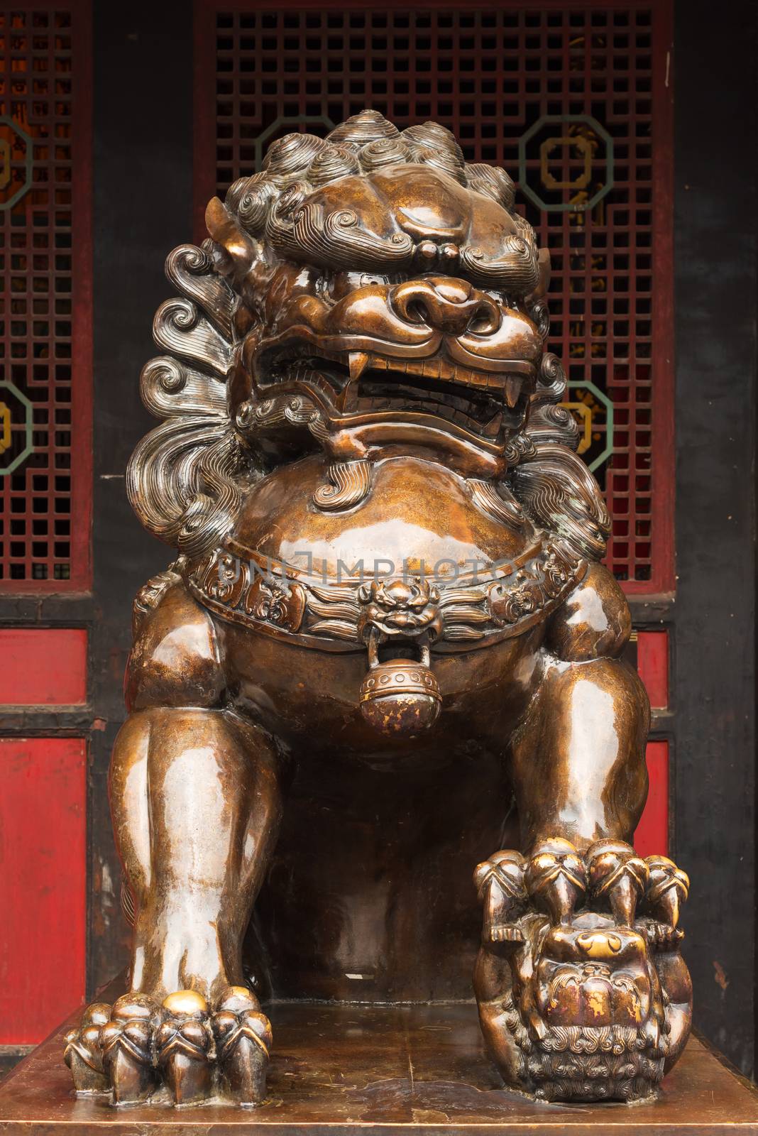 Lion bronze statue in front of a buddhist temple in China