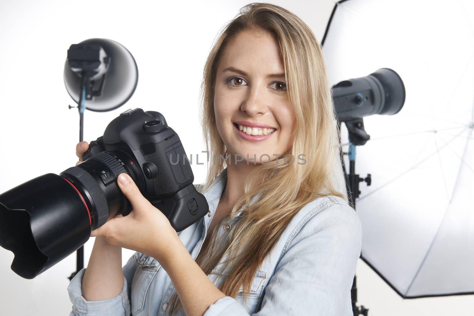 Female Professional Photographer Working In Studio by HWS