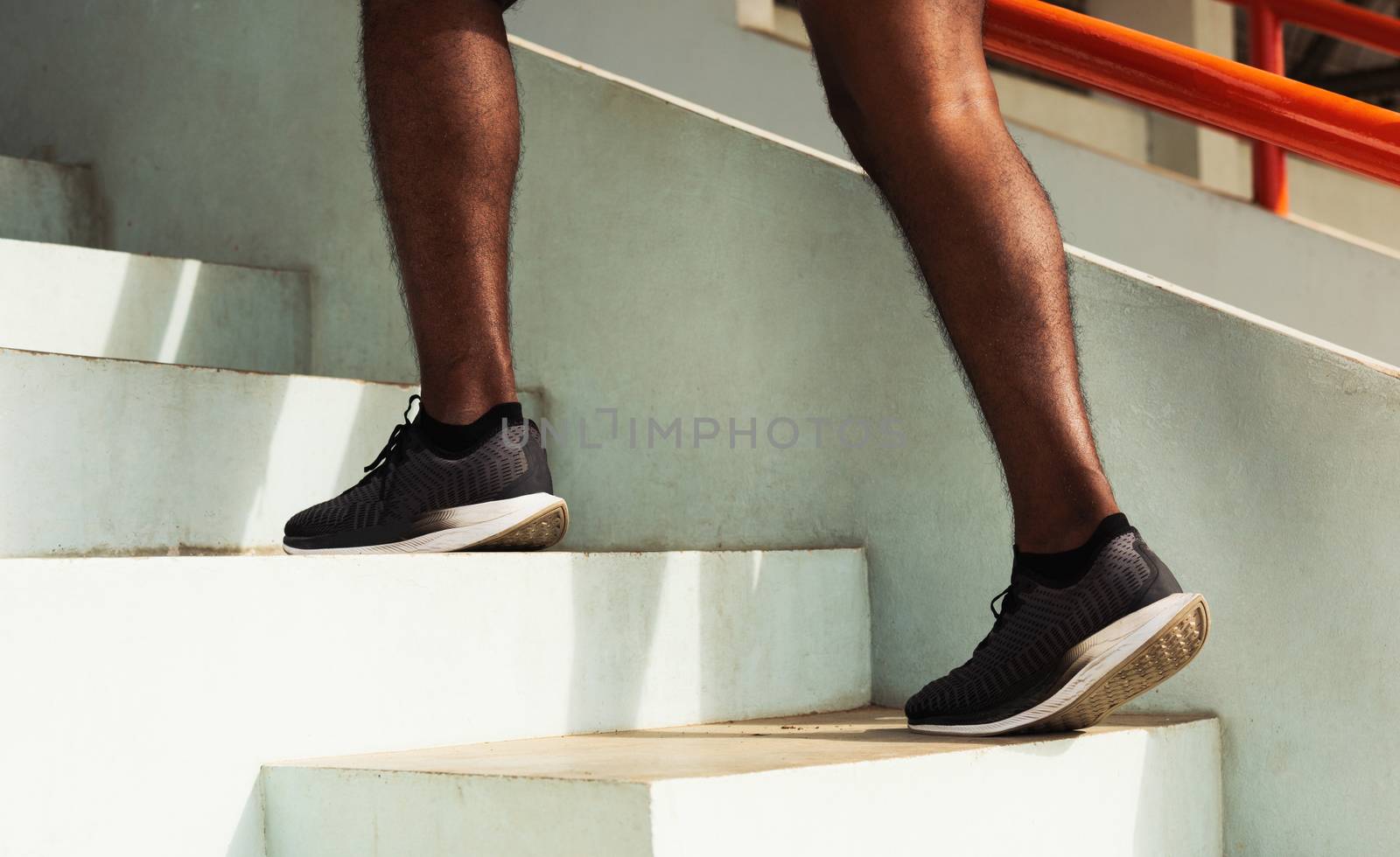 sport runner black man step running up to climbing stairs by Sorapop