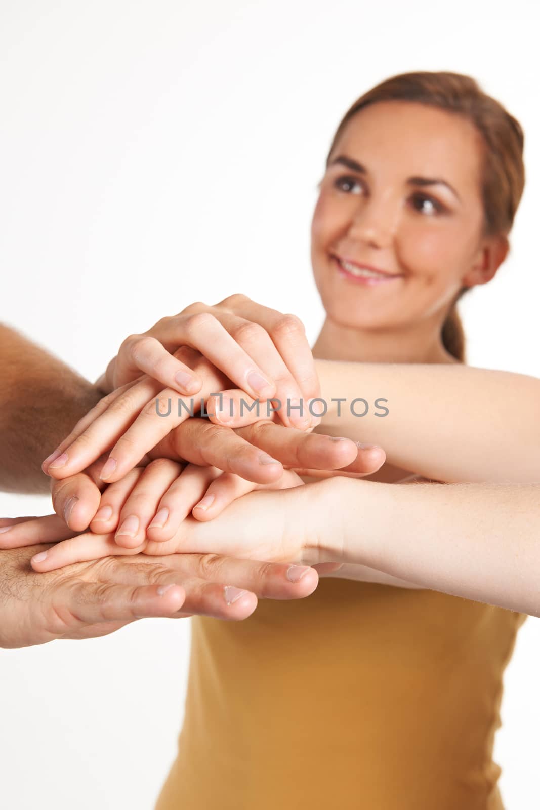 Group Of Young Friends Joining Hands Together by HWS