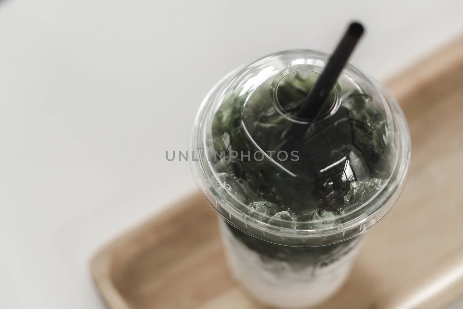 Closeup glass of matcha green tea shape on wood background with  by pt.pongsak@gmail.com