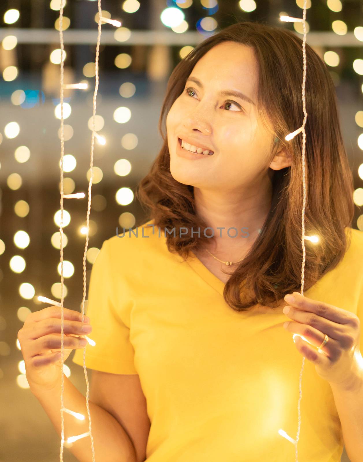 Asian girl smileing with bokeh light in christmas day, selective by pt.pongsak@gmail.com