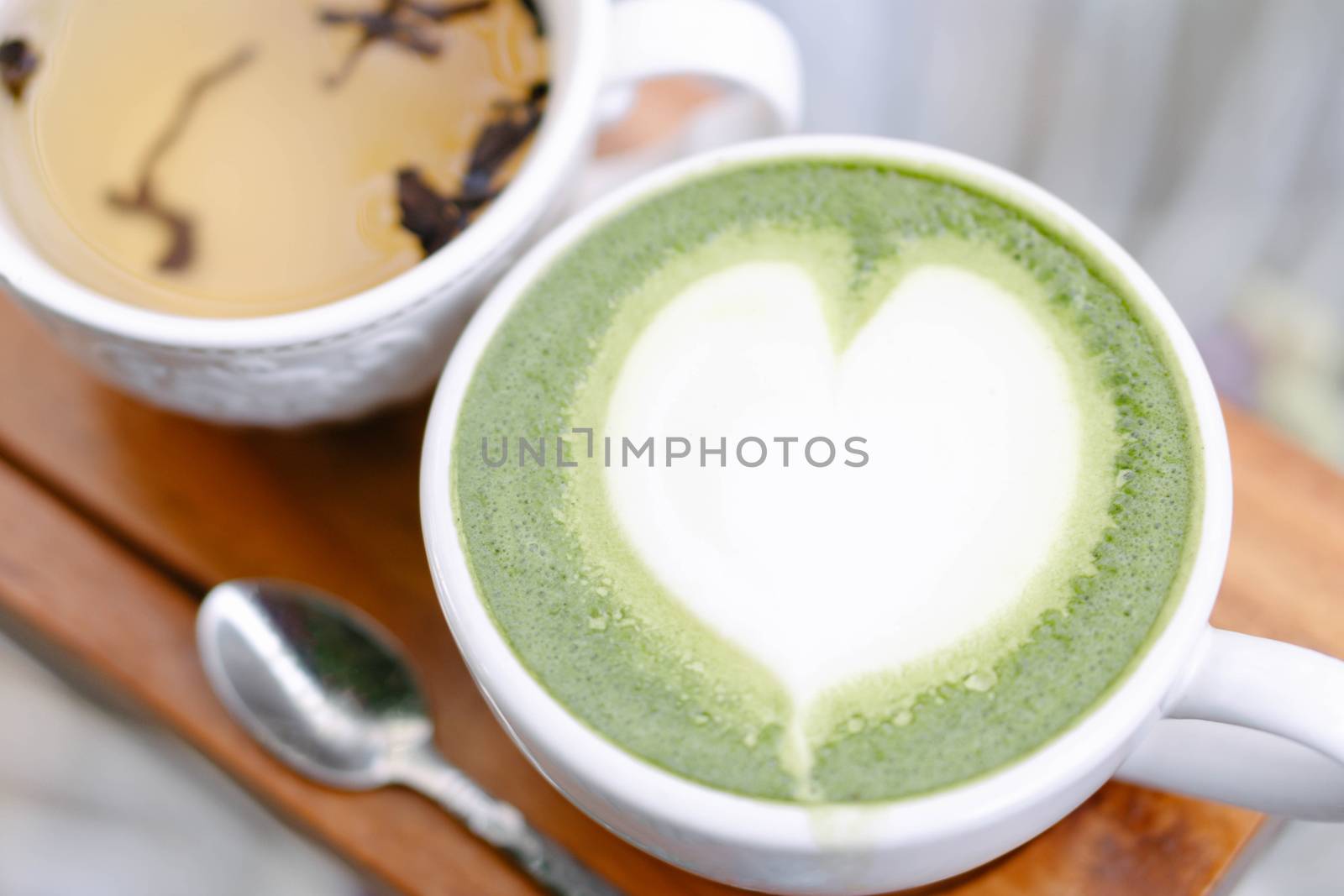 Closeup glass of matcha green tea shape on wood background with  by pt.pongsak@gmail.com