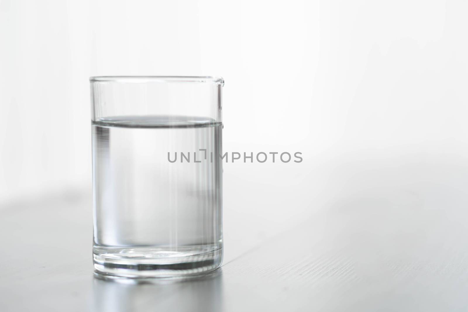 Glass of water on wood table with light in the morning, healthy  by pt.pongsak@gmail.com