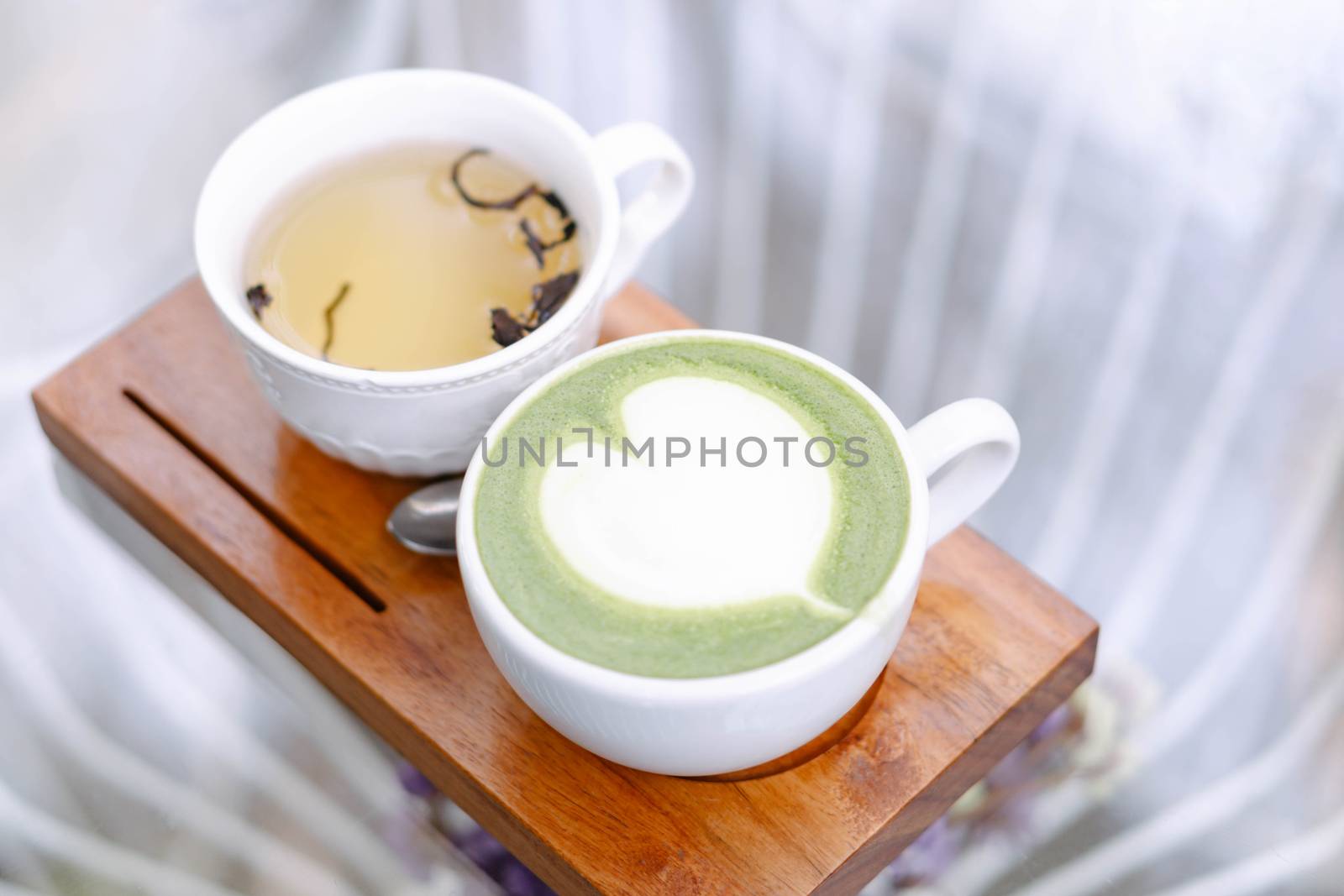Closeup glass of matcha green tea shape on wood background with vintage color, selective focus