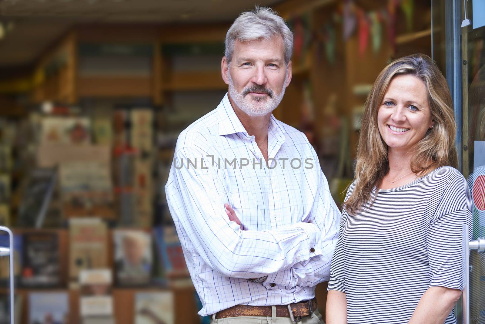 Portrait Of Couple Who Own Bookshop Outside Store