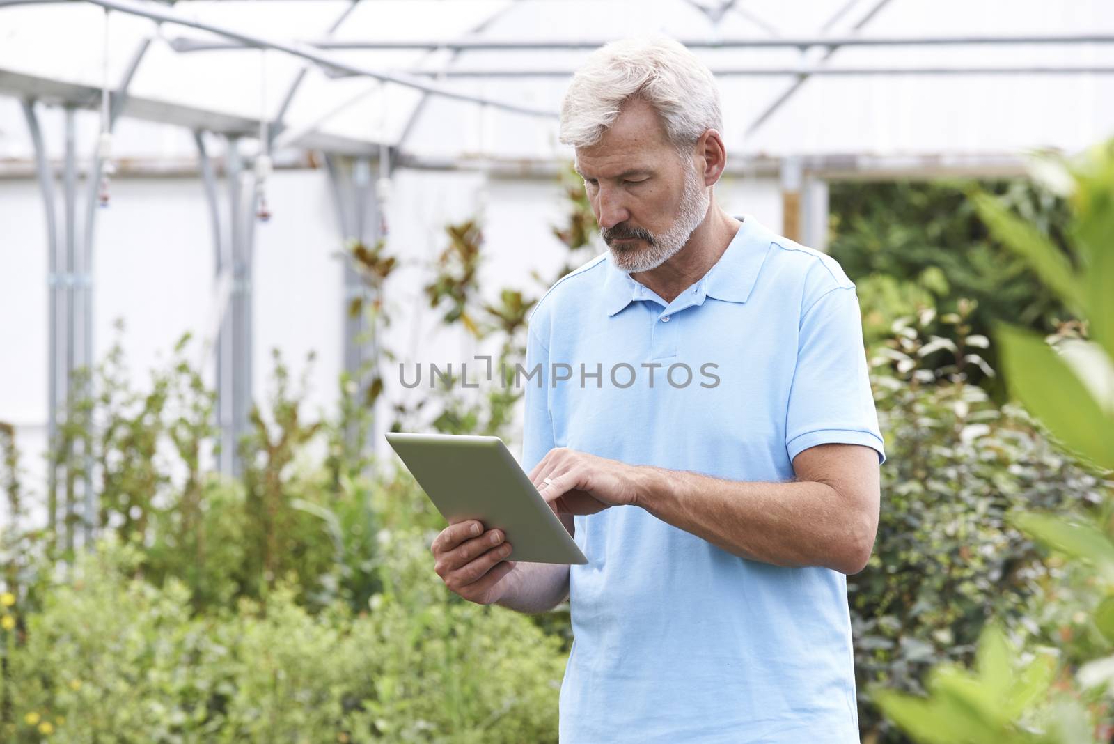 Sales Assistant In Garden Center With Digital Tablet by HWS