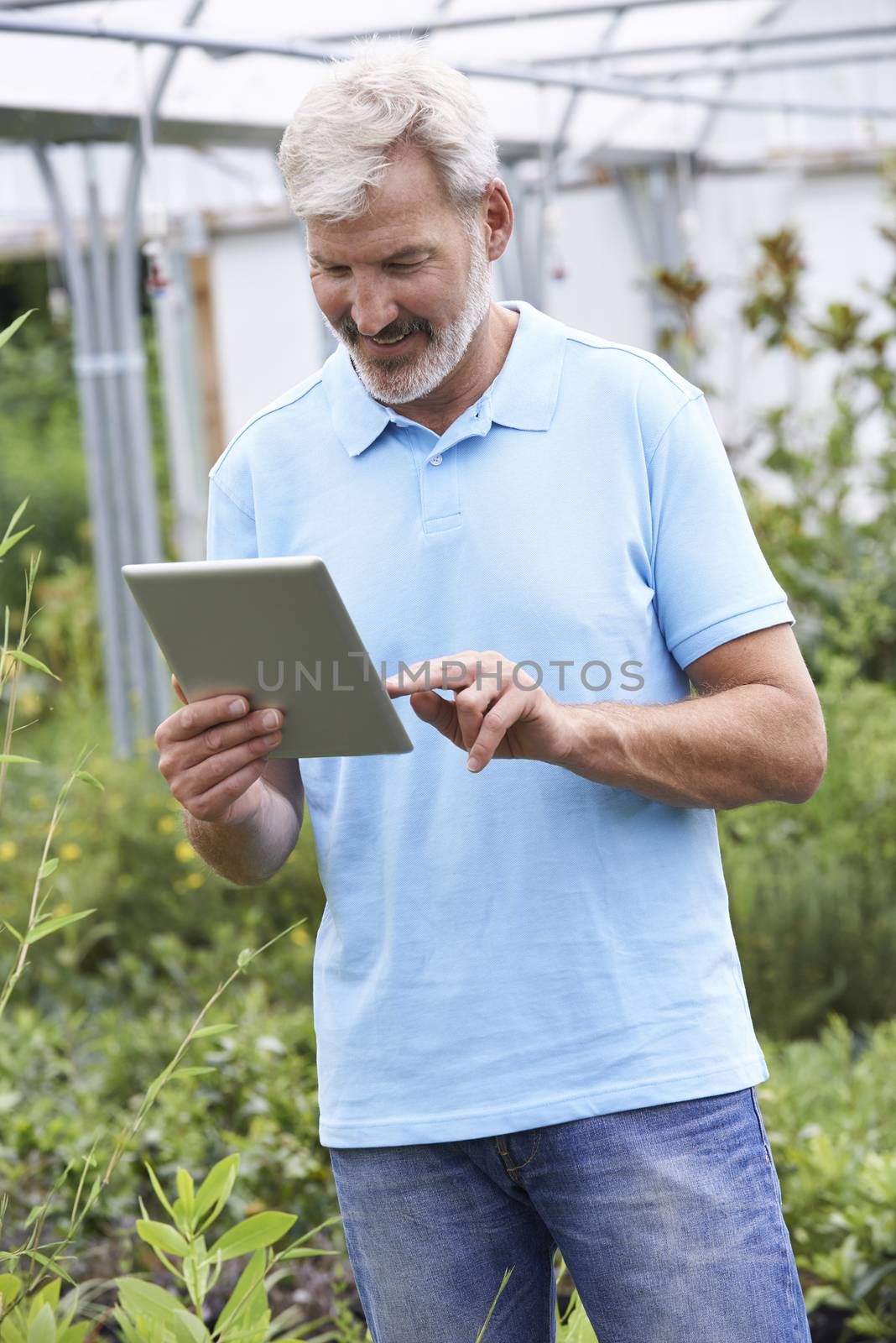 Sales Assistant In Garden Center With Digital Tablet