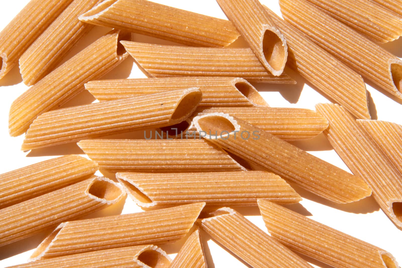 Pasta penne background wallpaper. italian food whole grain lunch ingredient. healthy eating full of carbohydrate. raw grain mediterranean food. Pile of macaroni close-up for healthy lifestyle.