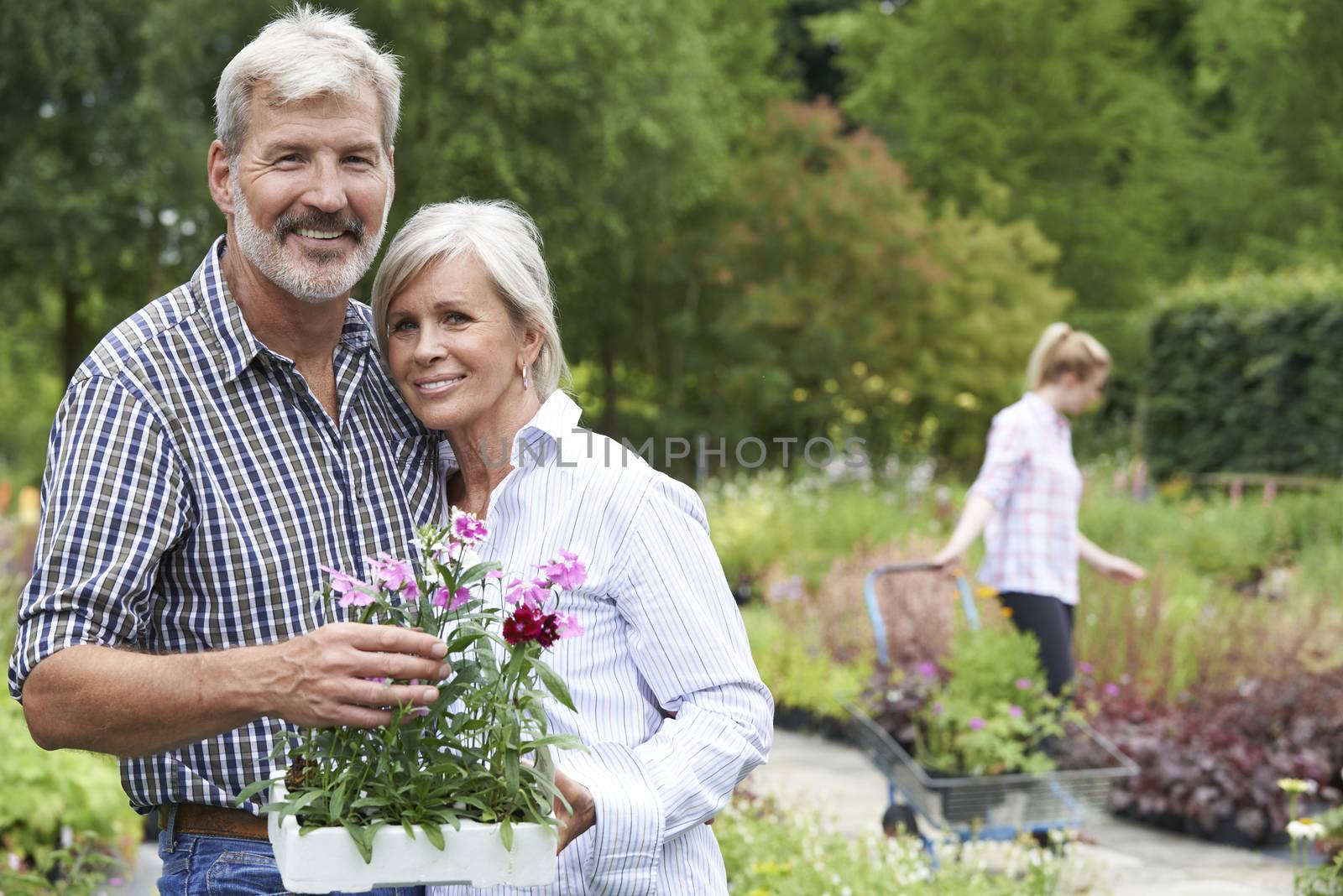 Portrait Of Mature Couple Shopping At Garden Center by HWS