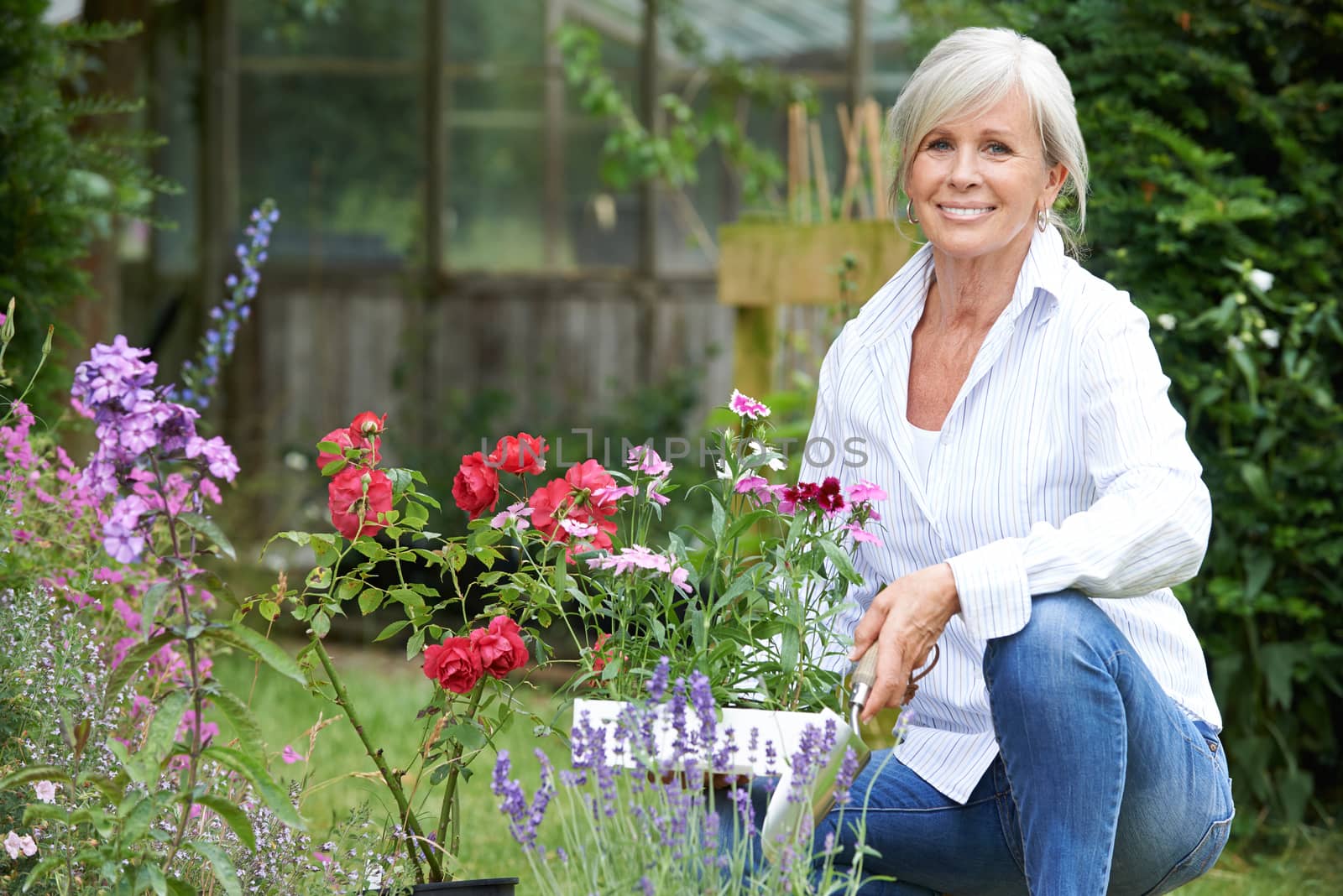 Portrait Of Mature Woman Gardening by HWS