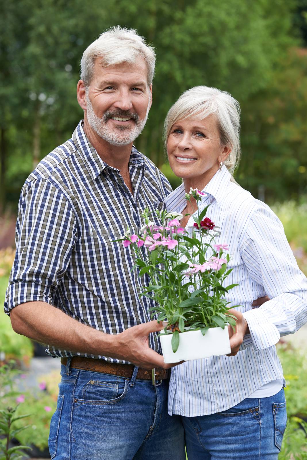 Portrait Of Mature Couple Shopping At Garden Center