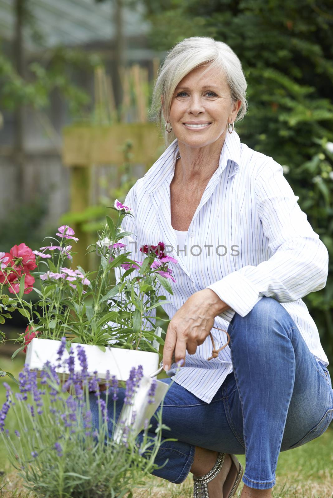 Portrait Of Mature Woman Gardening by HWS