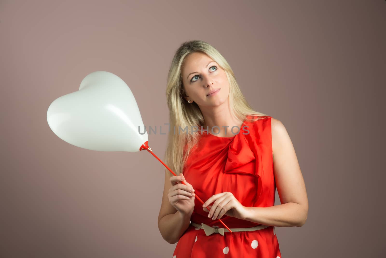 Romantic young woman with heart shaped balloon