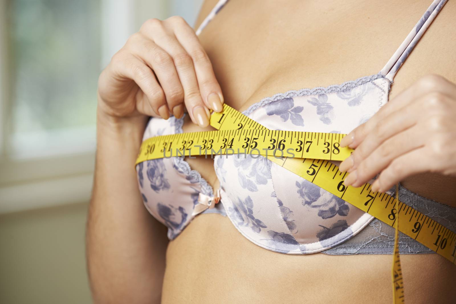 Woman Measuring Her Bra Size With Tape Measure