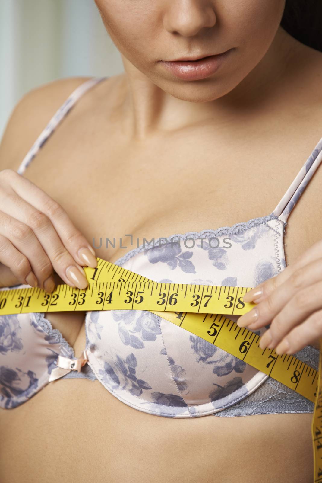 Woman Measuring Her Bra Size With Tape Measure