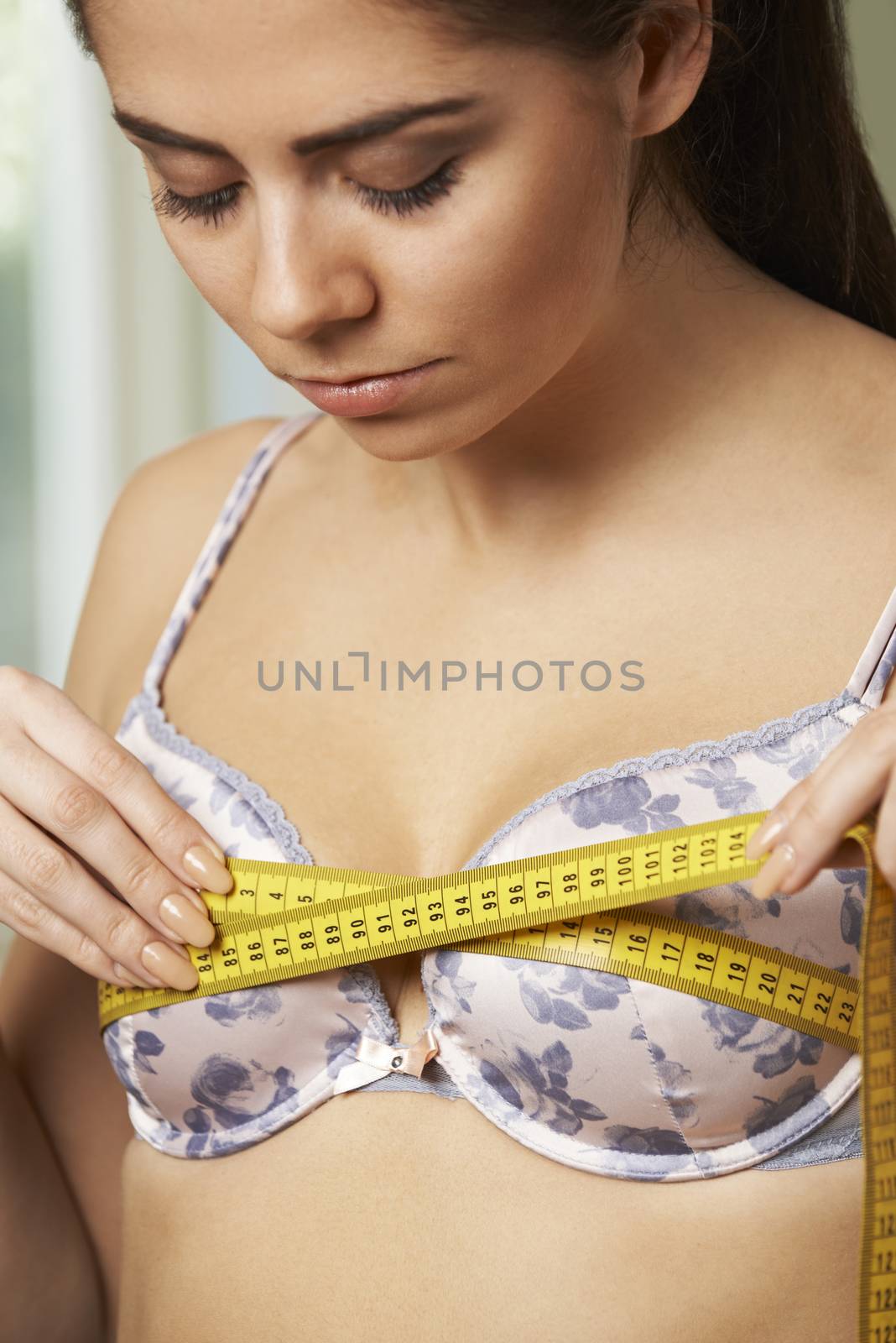 Woman Measuring Her Bra Size With Tape Measure by HWS