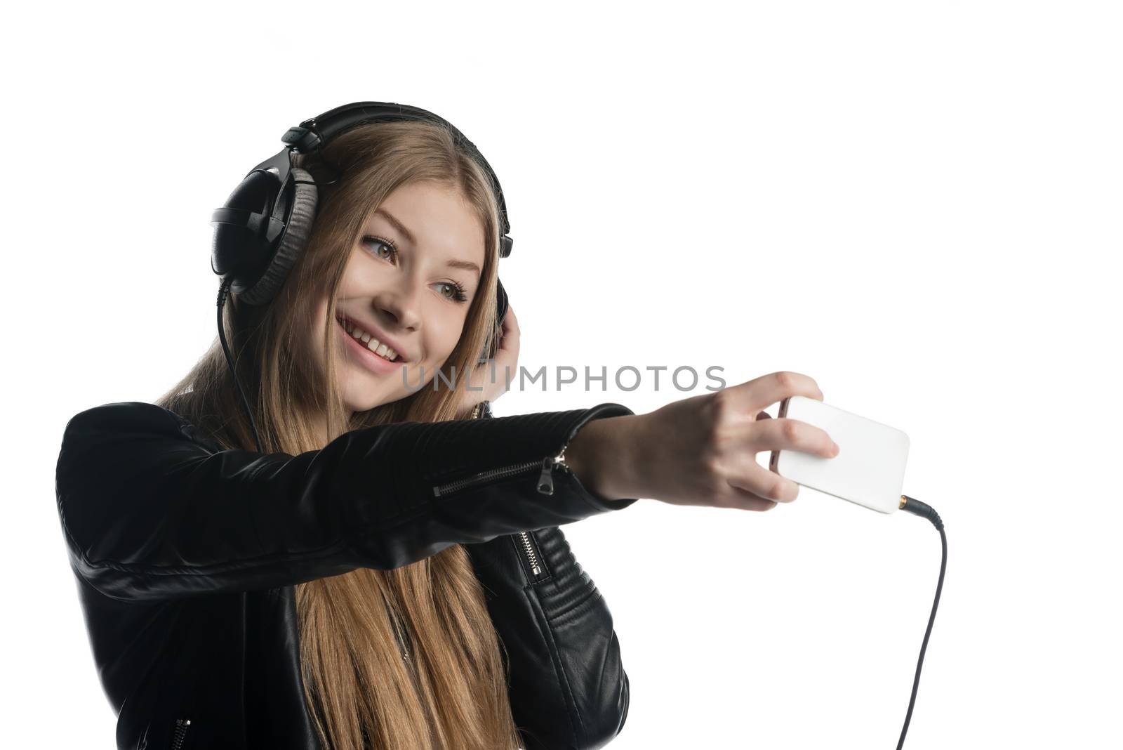 Happy face of a girl in wired headphones making selfie and a grimace by nemo269