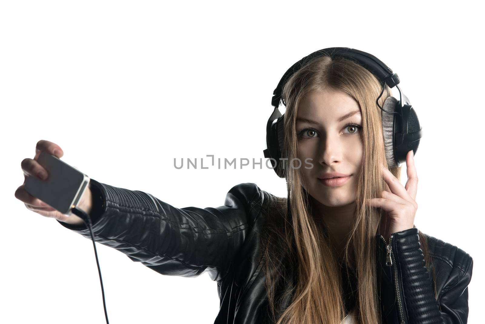 Young model in wired headphones listening music and making selfie by nemo269