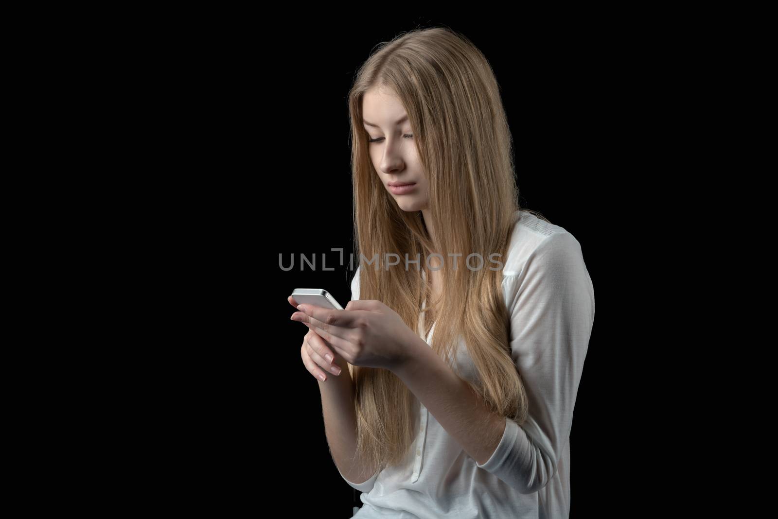 Attractive girl feels depressed after reading bad sms on her mobile phone by nemo269