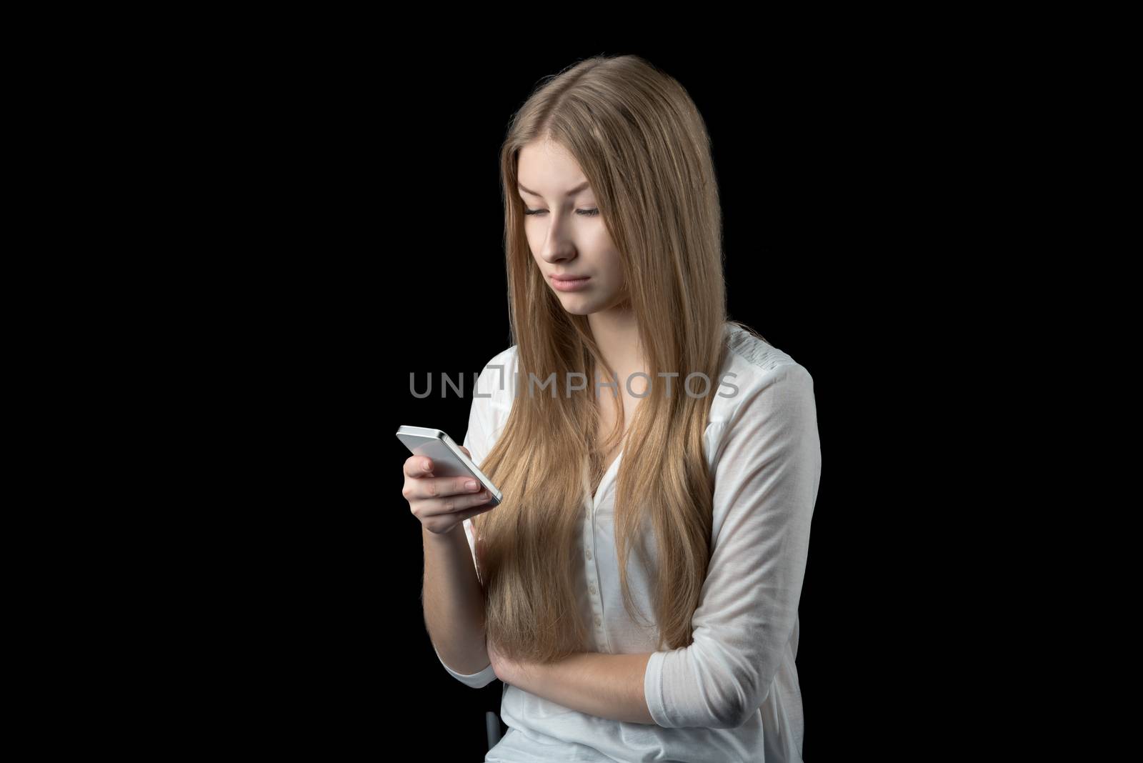 Attractive girl feels depressed after reading bad news on her mobile phone by nemo269