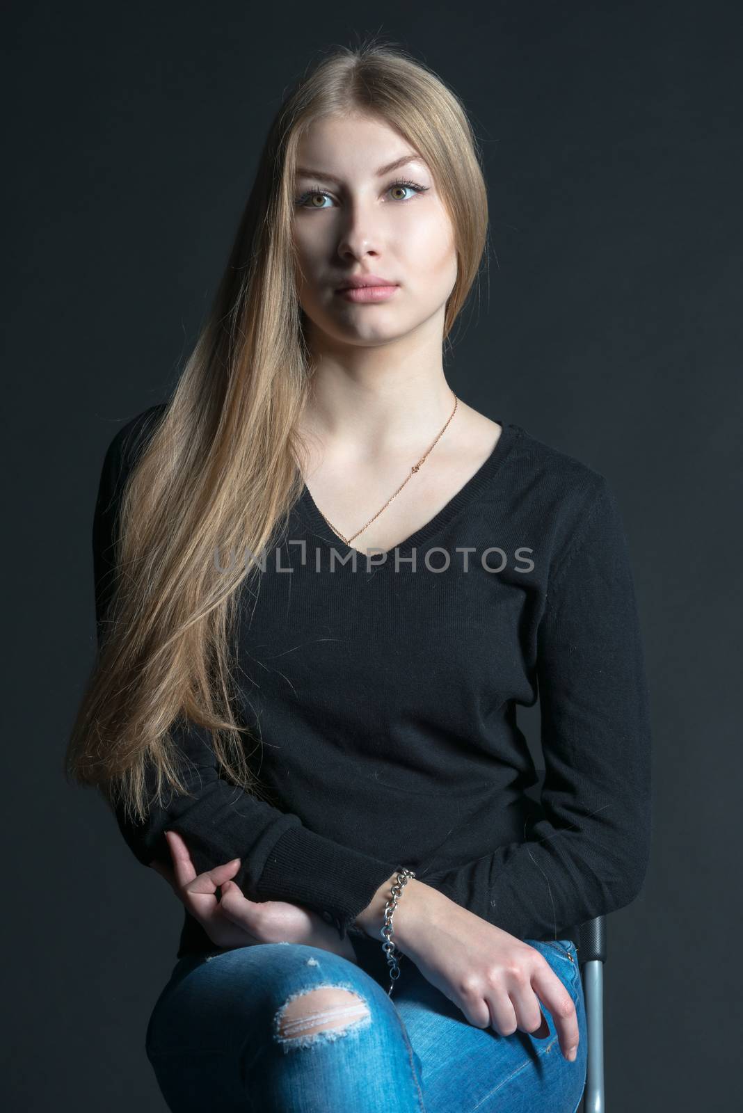 Spiritual and mental studio portrait of the Russian beautiful teenage girl with light long hair