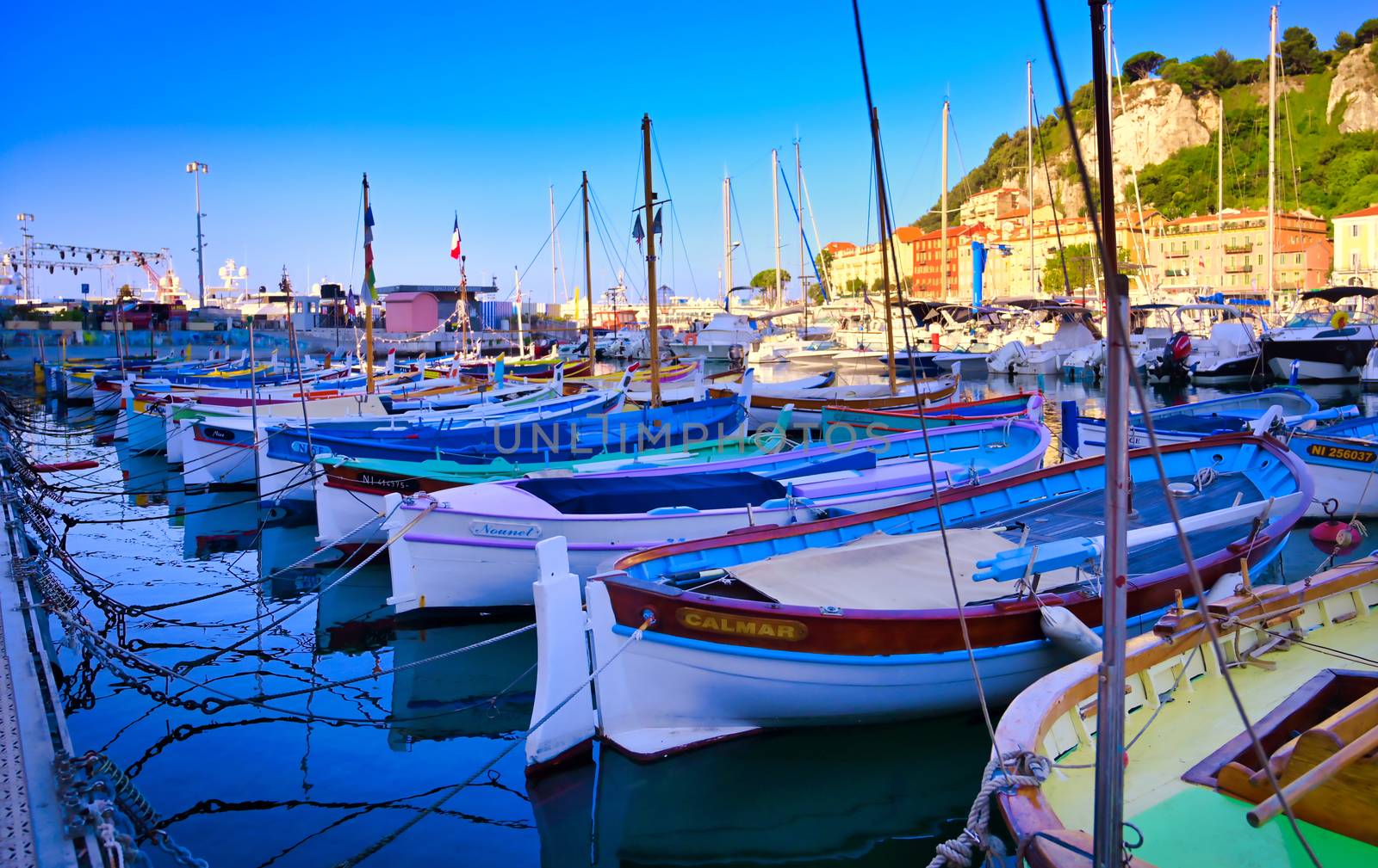 Nice, France - June 08, 2019 - Fishing boats docked in the port along the French Riviera on the Mediterranean Sea at Nice, France.