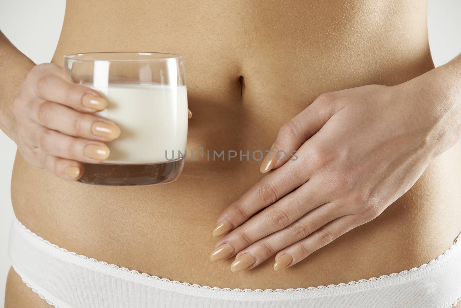 Close Up Of Dairy Intolerant Woman Holding Glass Of Milk