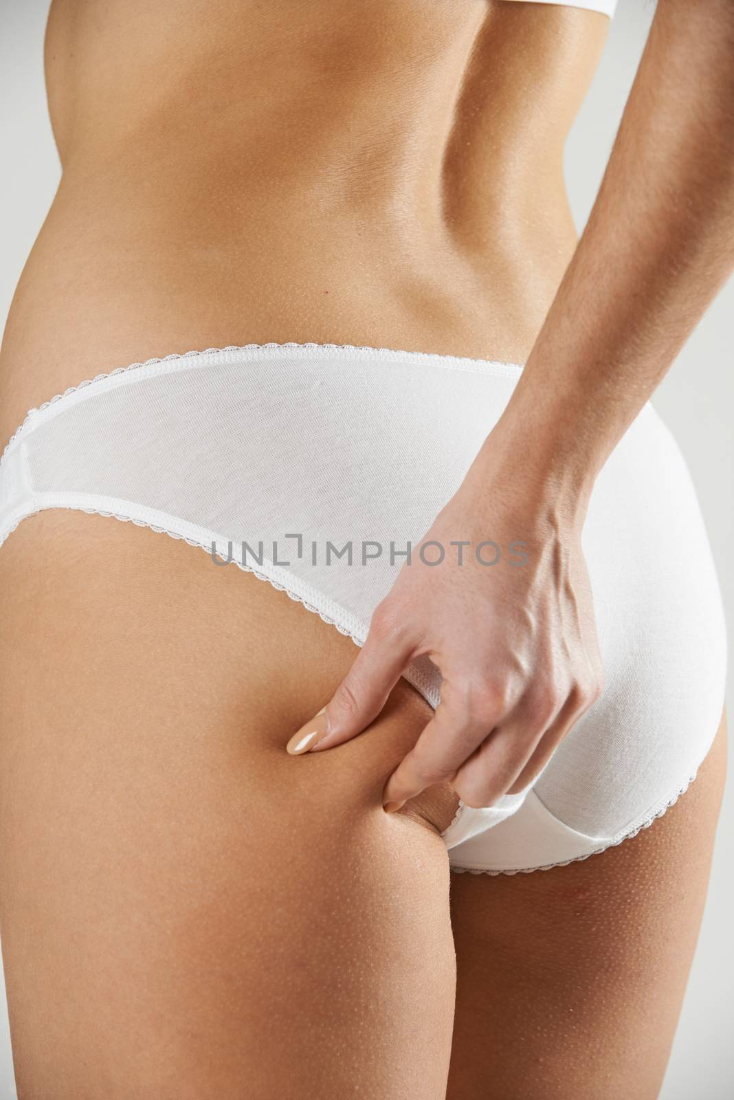 Close-Up Of Woman In Underwear Pinching Thigh