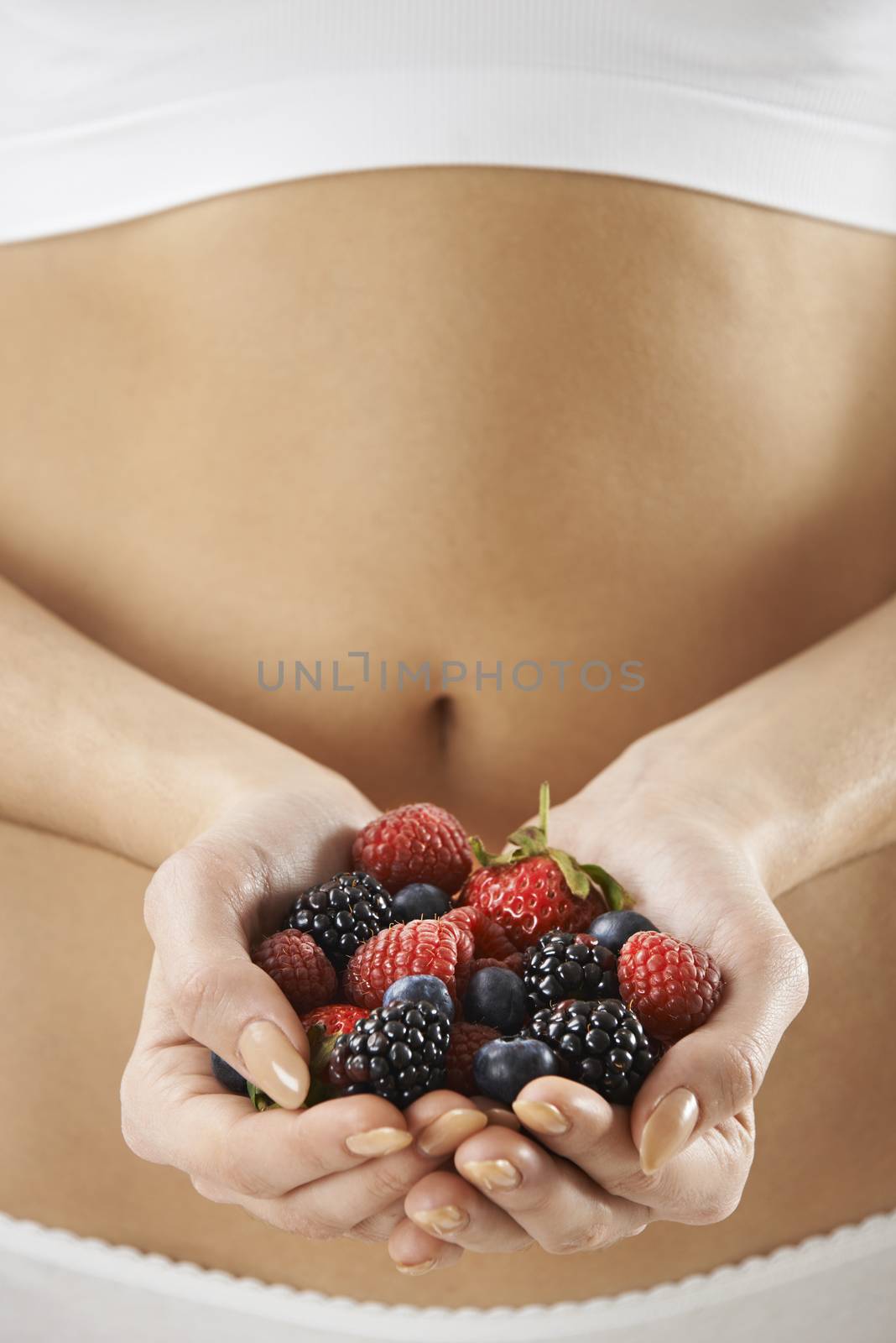 Close Up Of Woman In Underwear Holding Fresh Summer Berries by HWS