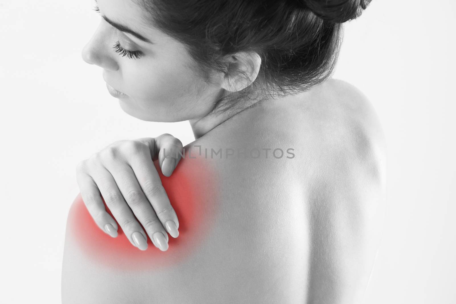 Monochrome Studio Shot Of Woman With Painful Shoulder