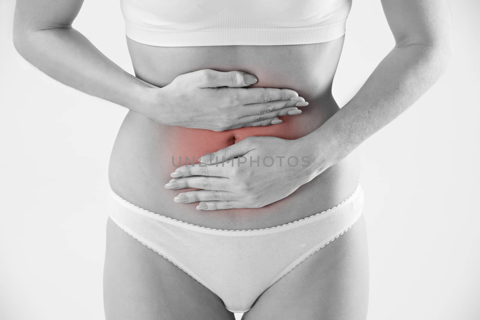 Monochrome Shot Of Woman In Underwear Holding Stomach In Pain