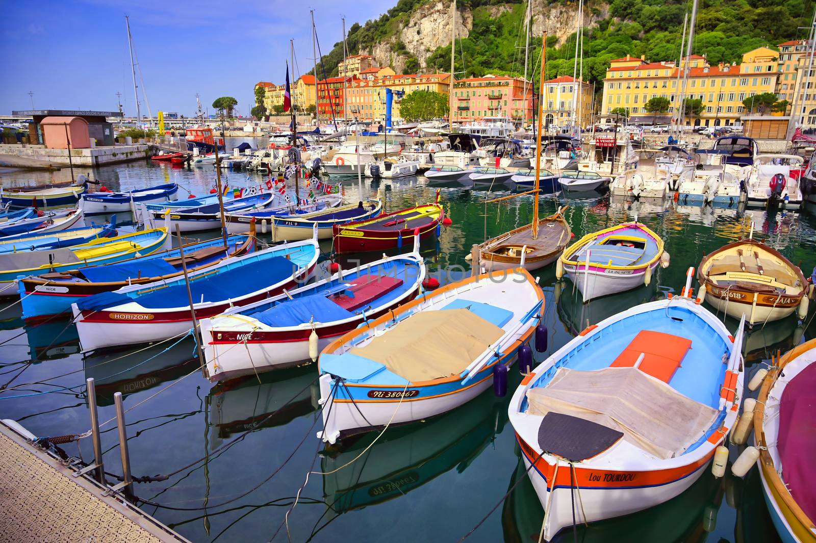 Nice, France - June 11, 2019 - Fishing boats docked in the port along the French Riviera on the Mediterranean Sea at Nice, France.