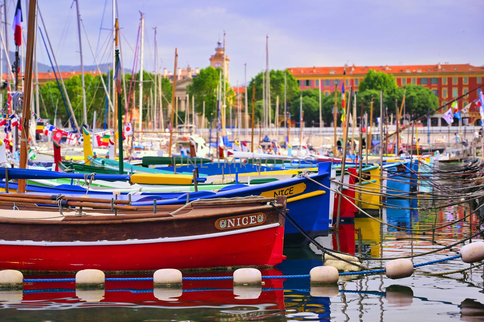 Nice, France - June 11, 2019 - Fishing boats docked in the port along the French Riviera on the Mediterranean Sea at Nice, France.