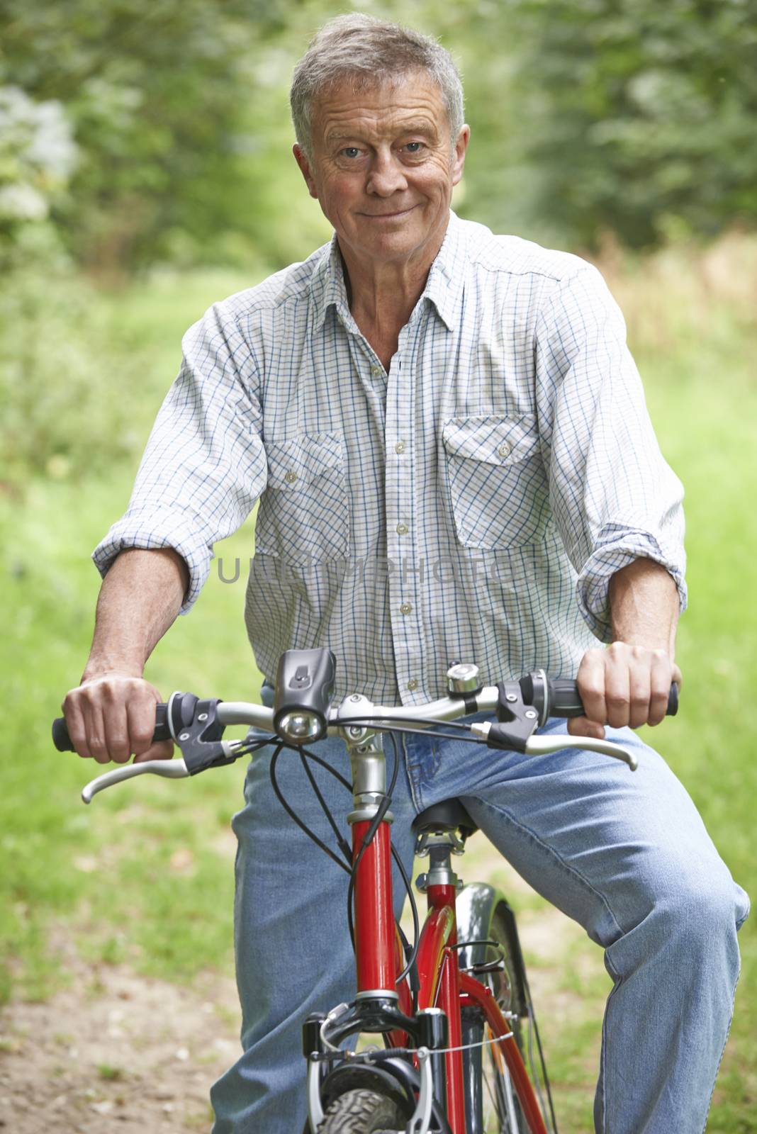 Senior Man Enjoying Cycle Ride In The Countryside by HWS