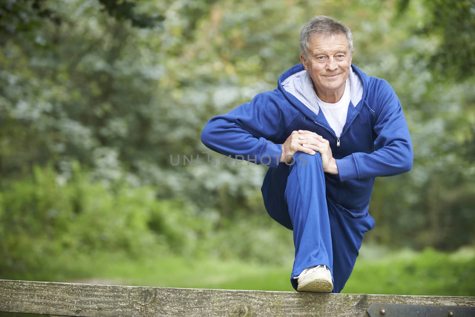 Senior Man Stretching On Countryside Run