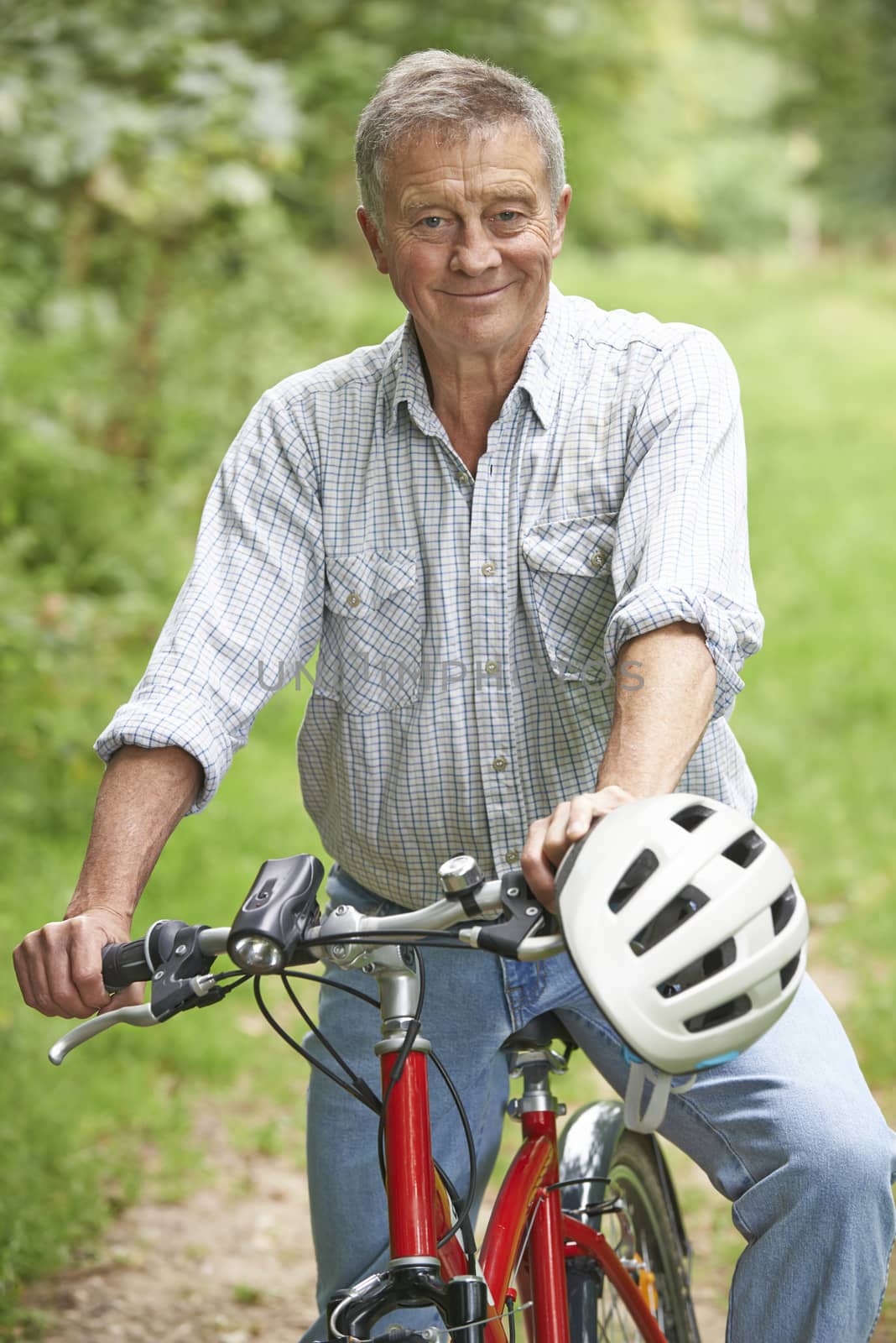 Senior Man Enjoying Cycle Ride In The Countryside by HWS