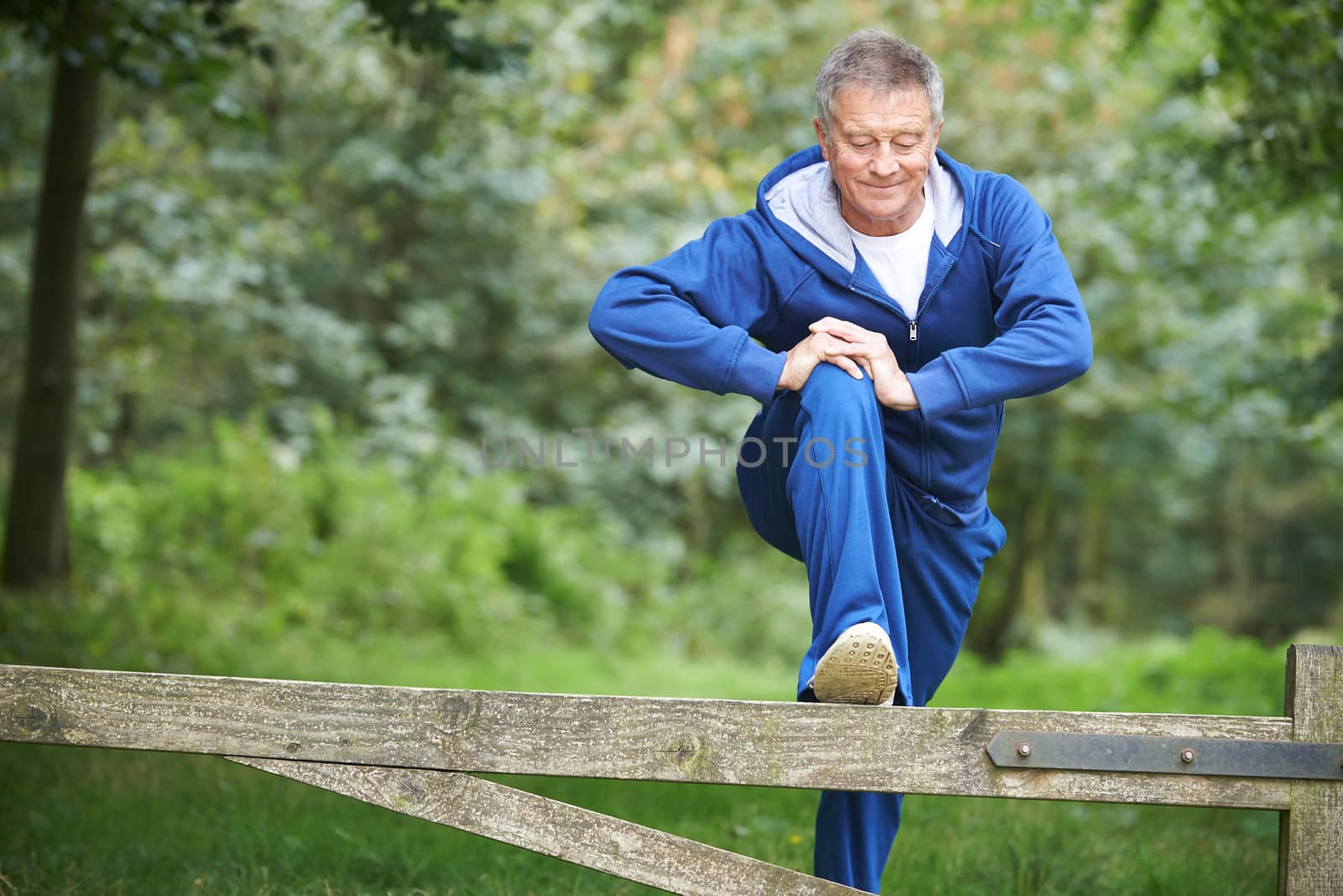 Senior Man Stretching On Countryside Run