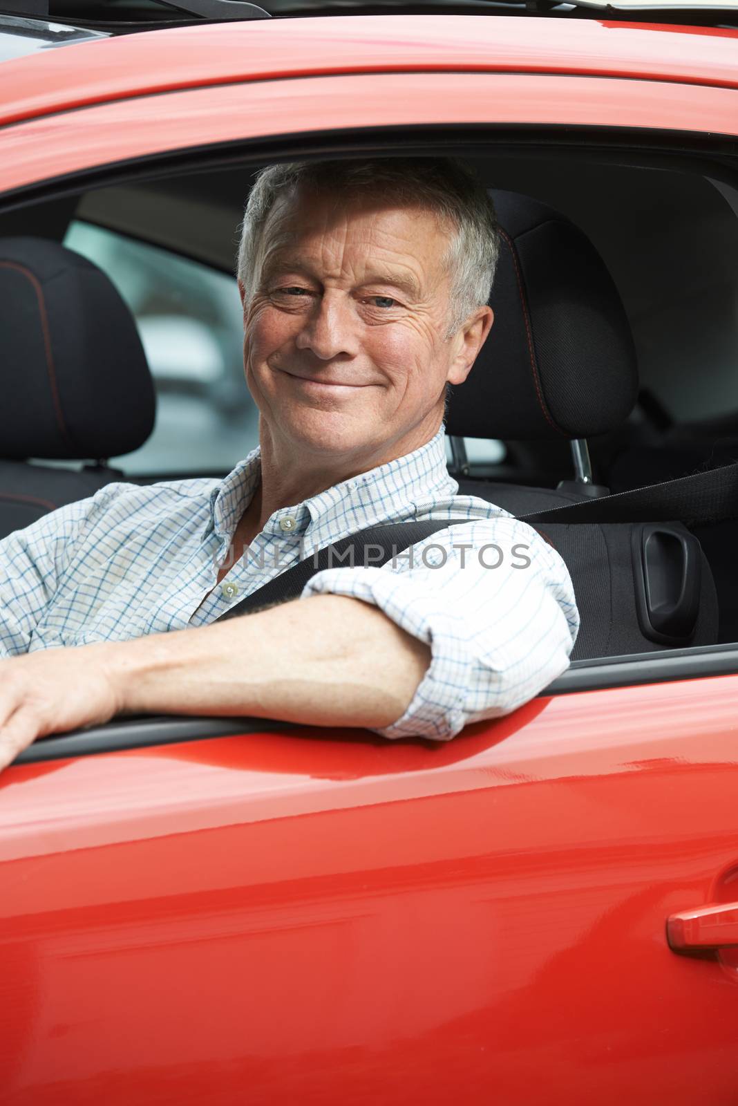 Portrait Of Senior Man Driving Car