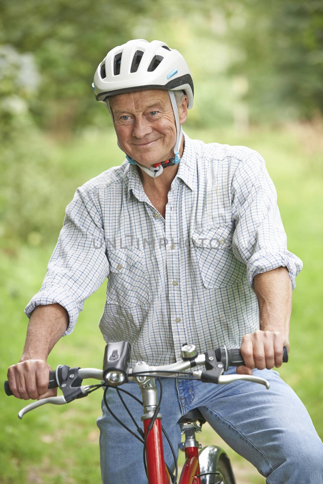 Senior Man Enjoying Cycle Ride In The Countryside by HWS