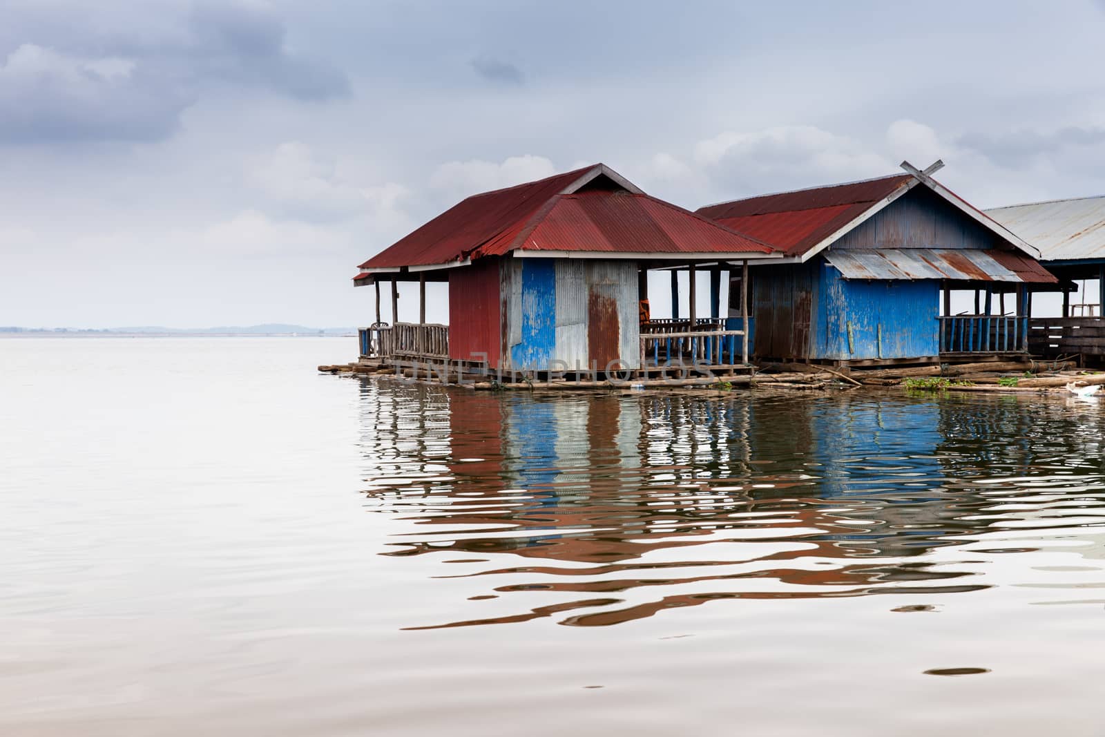 Floating wooden house village on river located at north of Thailand by pattierstock