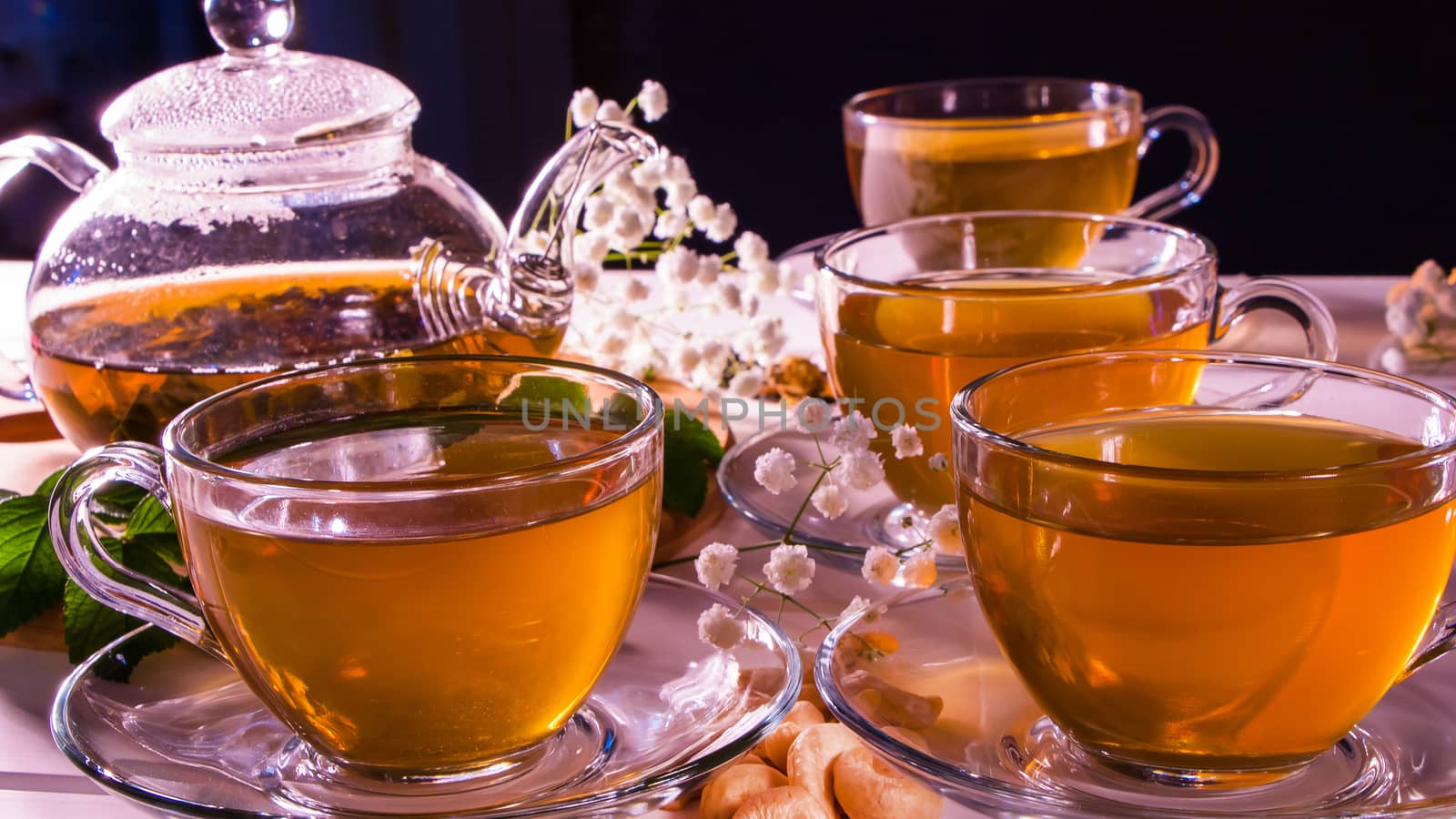 A Cup of green tea and a teapot. Flower tea with fruit slices. Tea ceremony, traditional drink. Afternoon tea, homelike. Flat lay. Oriental, cozy, preparation, heat, tradition, japanese, leafy, herbal