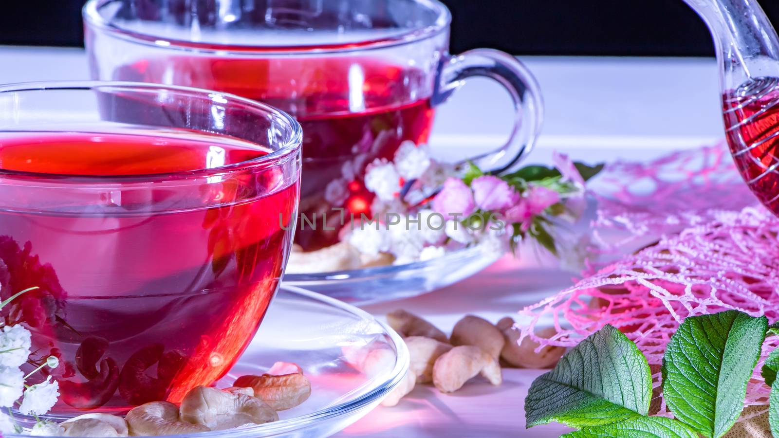 Red hot hibiscus tea in glass mug. Tea time: cup of tea, carcade, karkade, rooibos. Oriental, cozy, ceremony, tradition, japanese, leafy, hygge, autumn, 5 o'clock, afternoon tea