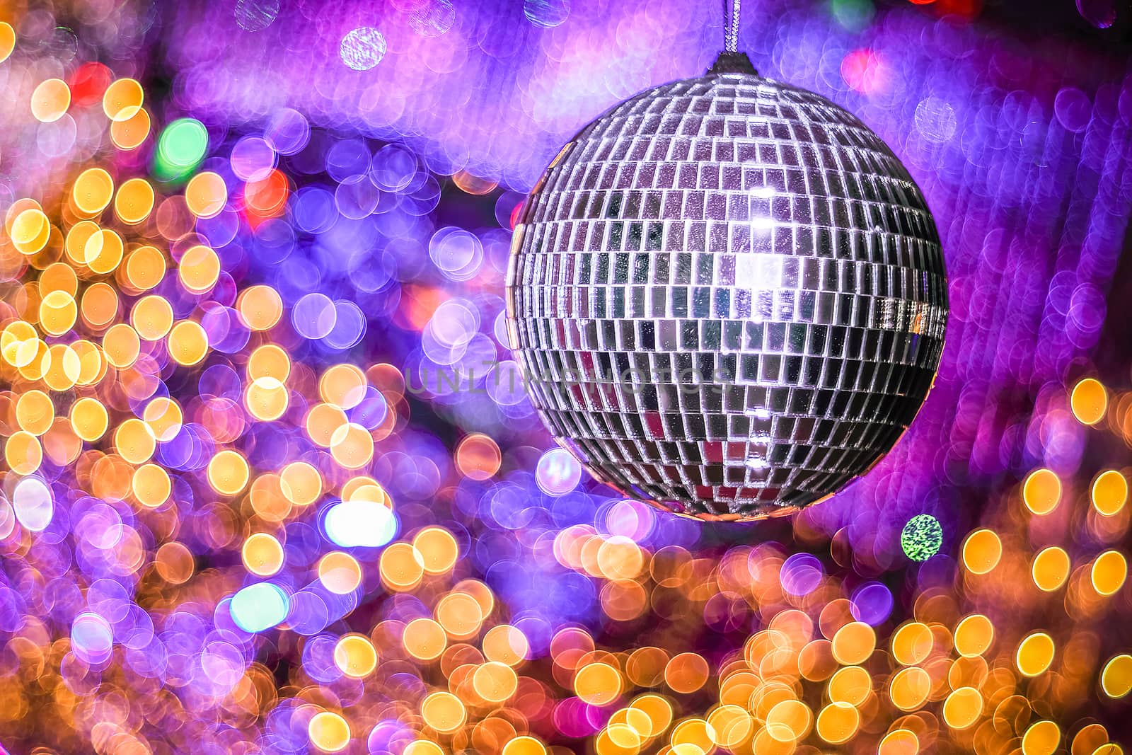 Disco ball with with bokeh defocused lights. Night party background photo. Disco party. Blurred, abstract background. Copy space.