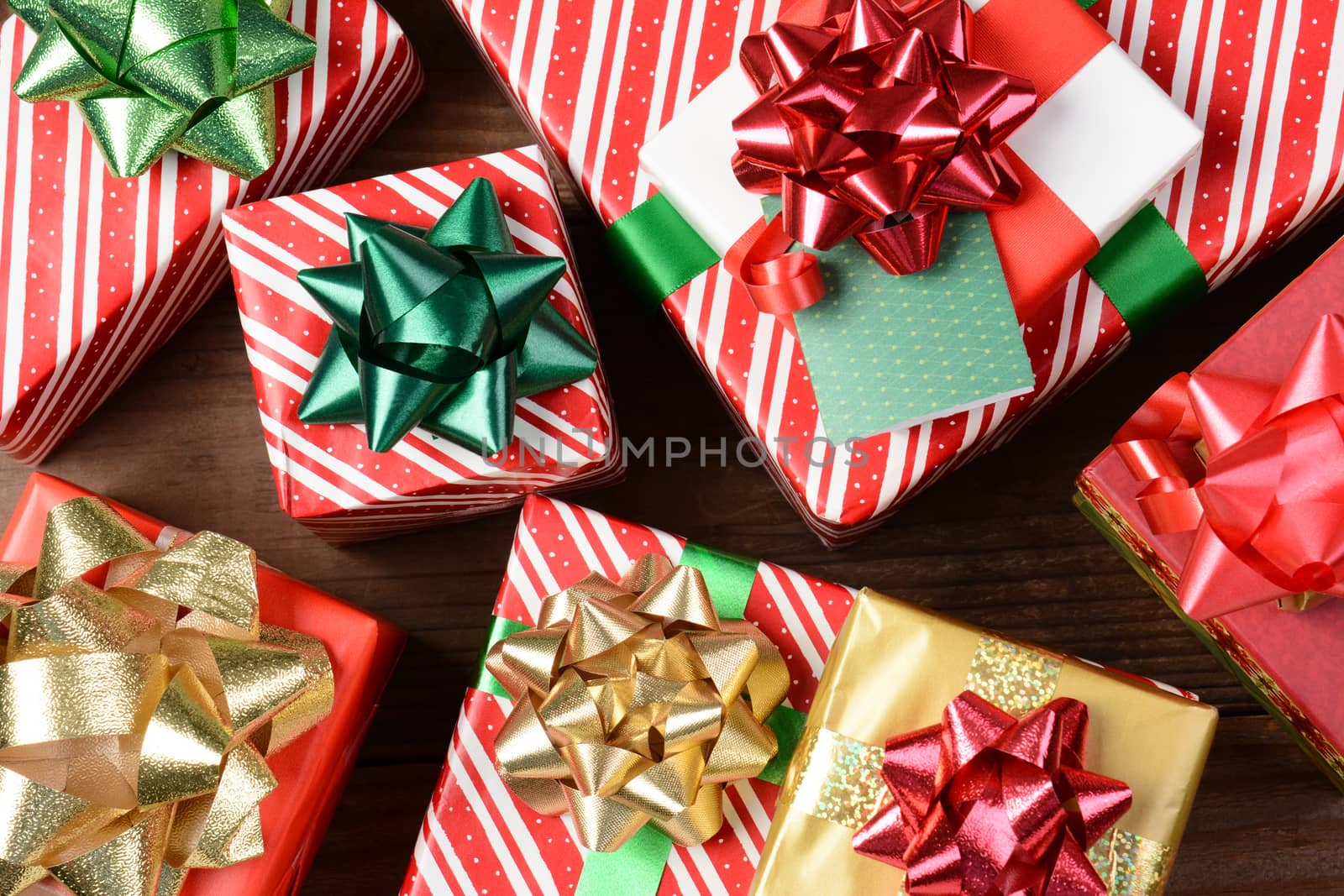 Overhead view of a group of wrapped Christmas presents. Horizontal format filling the frame.