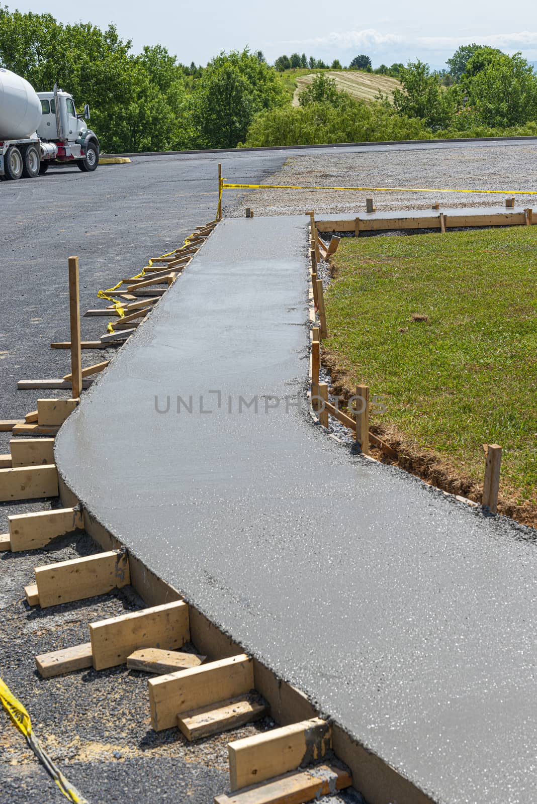 Vertical shot of a freshly poured concrete sidewalk.