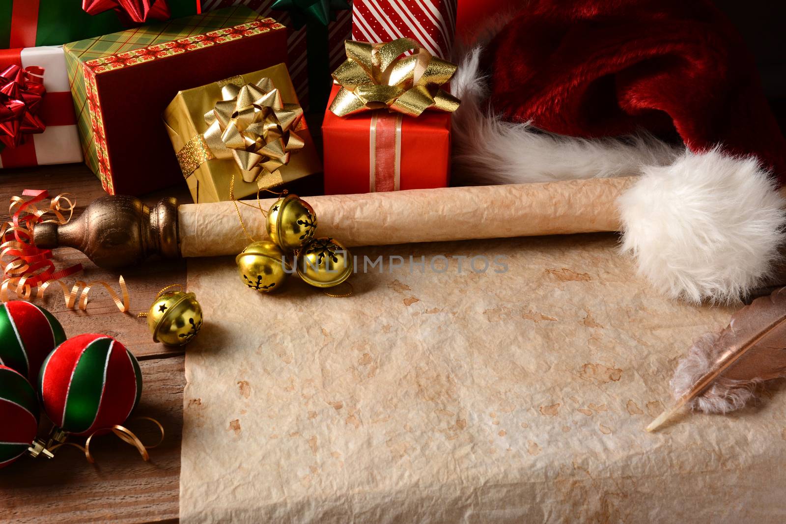 A Christmas Still Life with an old parchment scroll, presents, ornaments and a Santa Hat. Closeup in horizontal format with strong side light.  This could be Santa's North Pole headquarters where he is about to begin writing his Naughty and Nice list.