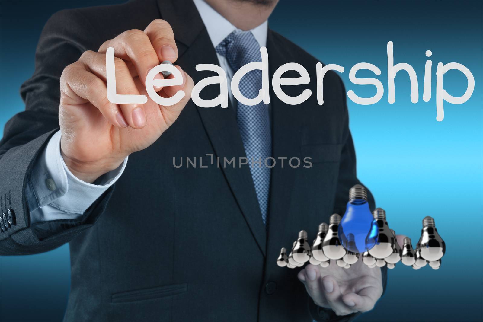 businessman hand shows light as leadership concept