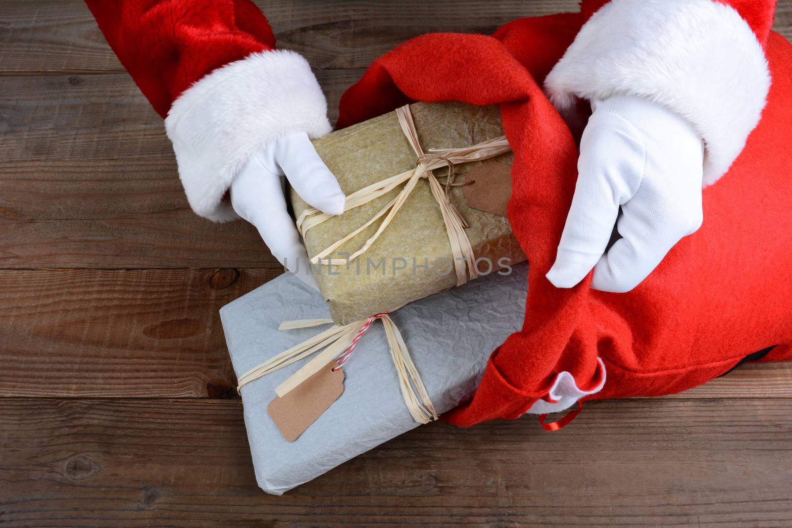 Closeup of Santa Claus putting packages in his bag on Christmas Eve. 